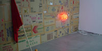 A orange color neon sign that can be read But in Japanese on the wall.