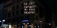 A large sclae light projection on the facade of a bank in Helsinki at night.