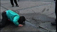 The artist is drinking water on the street in the former east Berlin.